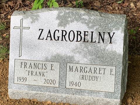 A picture containing text, gravestone, plaque
Description automatically generated
